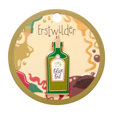Enamel pin shaped like an olive oil bottle with a label on a white background - from Erstwilder's 2025 Condiments collection