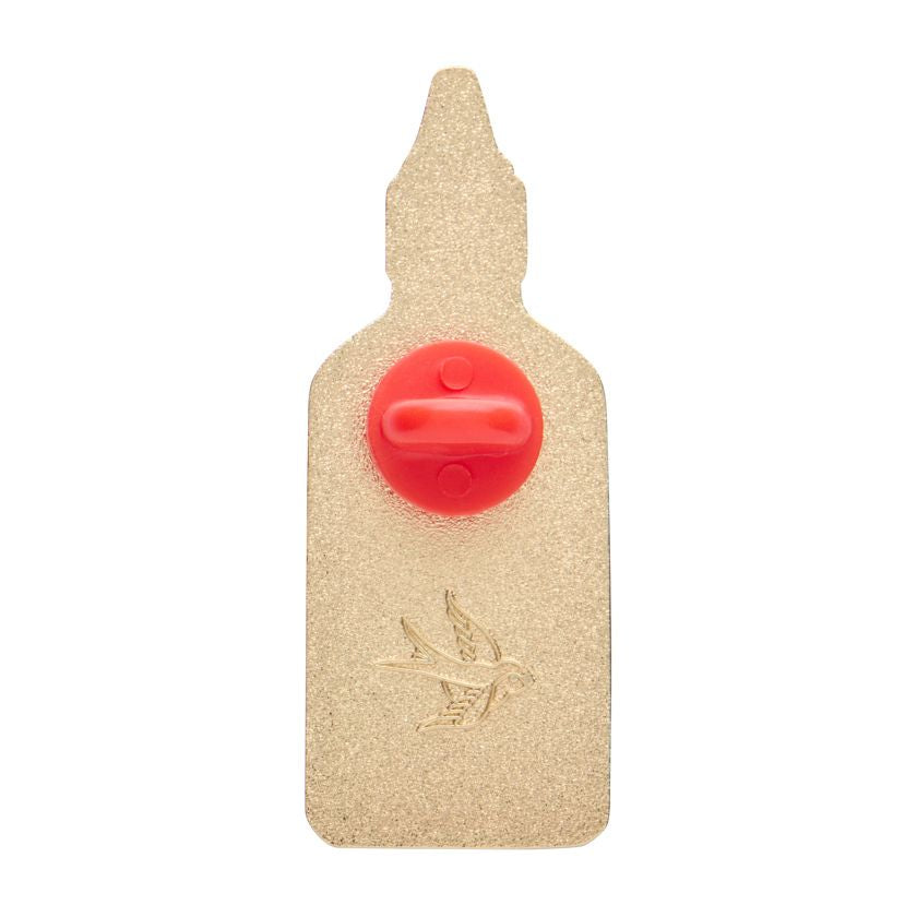 Hot chilli sauce bottle-shaped enamel pin with red body, green cap, and gold accents on a white background. Erstwilder's chilli enamel pin from their 2025 Condiments collection