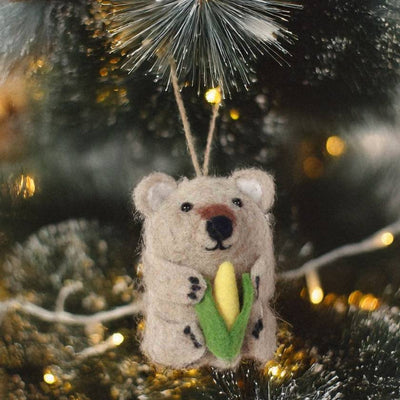Felted bear ornament holding a corn cob on a white background by La La Land 