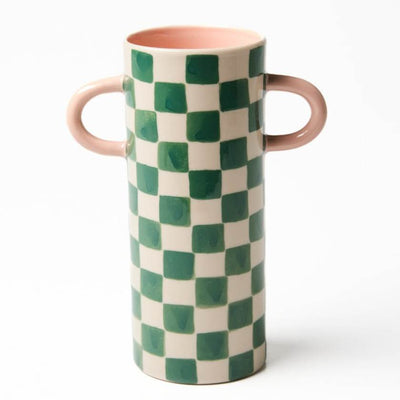 Ceramic vase with green and white checkered pattern and pink handles on a white background
