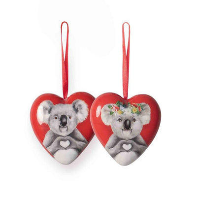 Two heart-shaped ornaments with koala designs on a white background