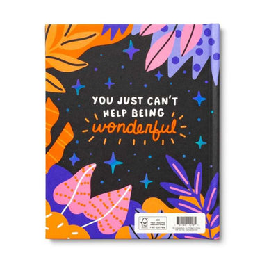 Notebook with colorful design and motivational quote on a white background