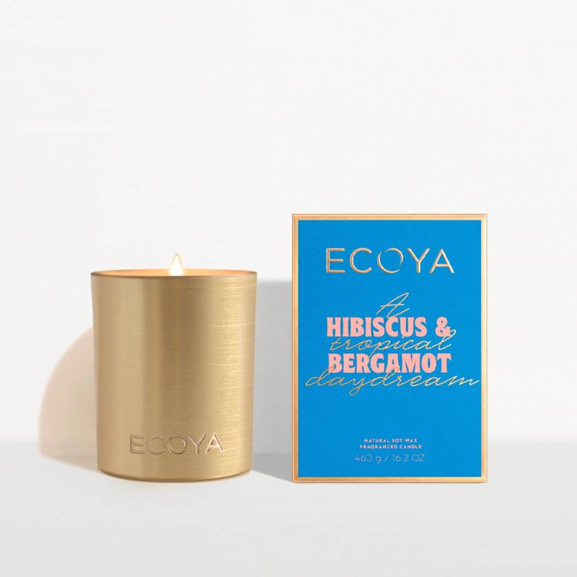 Gold candle with blue Ecoya packaging on a white background
