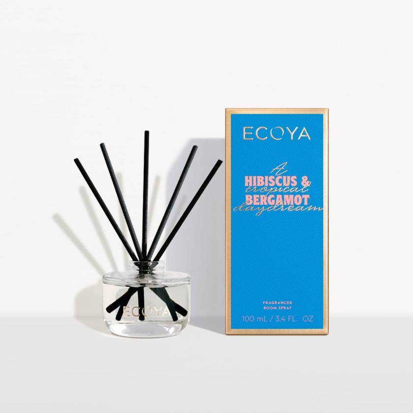 Ecoya diffuser with black sticks and a blue box on a white background
