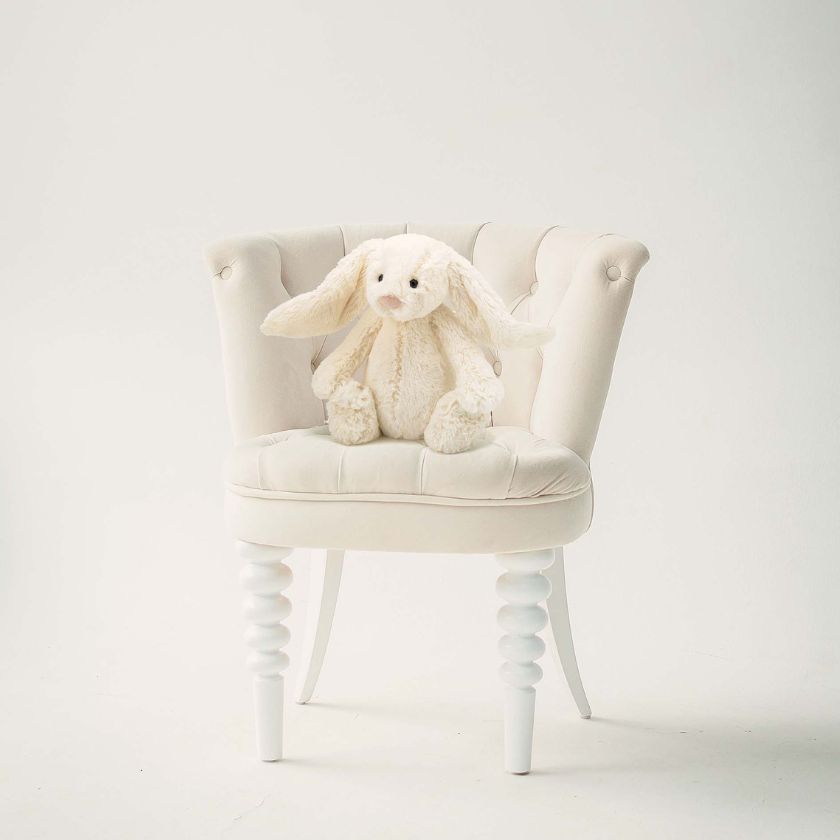 Jellycat Bashful Bunny in Cream - Medium sitting on chair