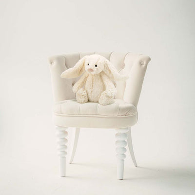 Jellycat Bashful Bunny in Cream - Medium sitting on chair