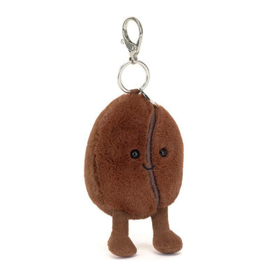 Plush coffee bean keychain with a face on a white background. Jellycat Amuseables Coffee Bean Bag Charm. Jellycat Stockist in Newcastle, NSW at Zebra Finch