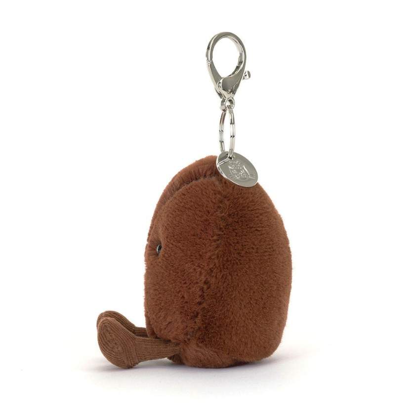 Plush coffee bean keychain with a face on a white background. Jellycat Amuseables Coffee Bean Bag Charm. Jellycat Stockist in Newcastle, NSW at Zebra Finch