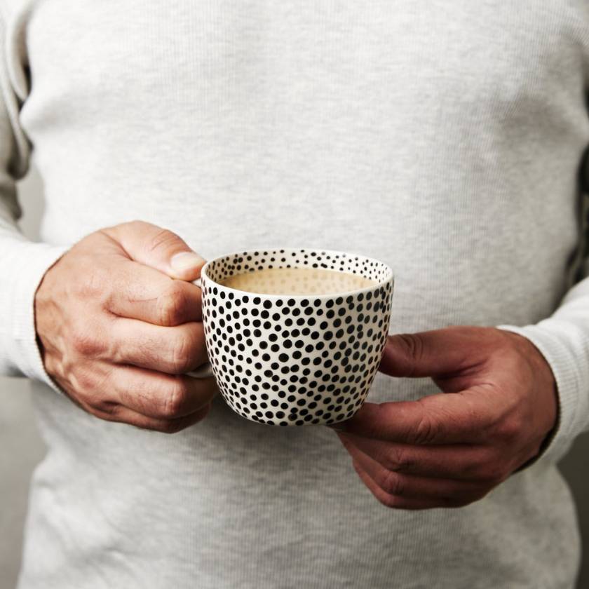 Person holding a black and white polka dot mug with a light-colored interior by Jones and Co | Stockist at Zebra Finch in Newcastle, NSW