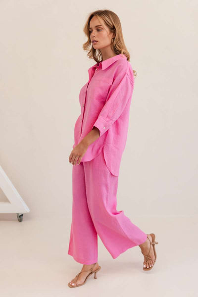Woman wearing a bright pink outfit against a white background by Kaliedo
