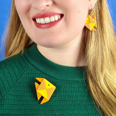 The memorable goldfish brooch on by Erstwilder from their 2023 Origami collection