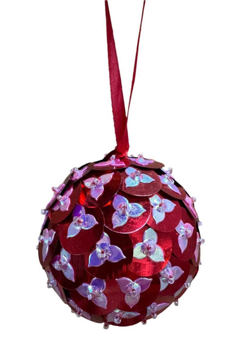 Decorative red ornament with floral patterns on a white background