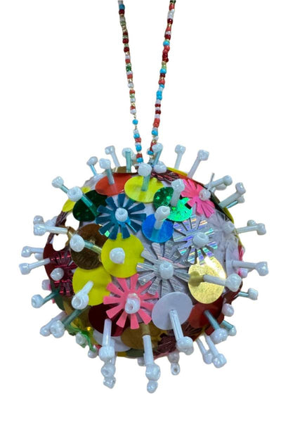 Colorful spherical ornament with white spikes on a white background