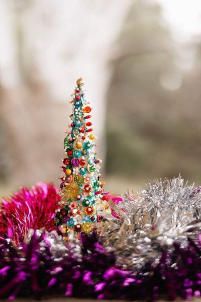 Colorful Christmas tree ornament with tinsel on a blurred background
