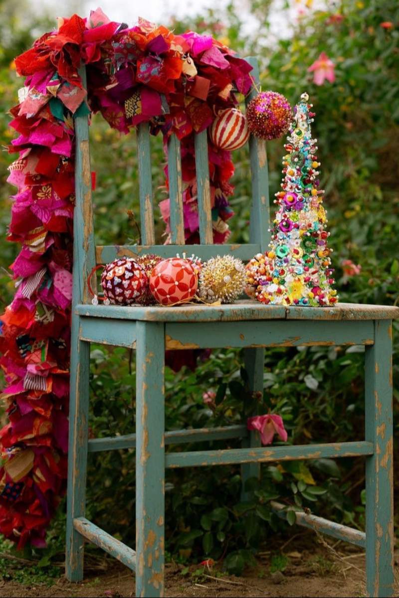 Decorative chair with colorful flowers and ornaments against a natural background