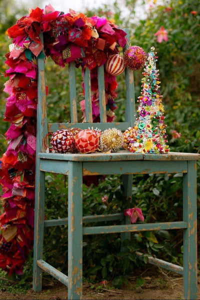 Decorative chair with colorful flowers and ornaments against a natural background