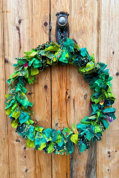 Colorful fabric wreath on a wooden door by Mink and Me