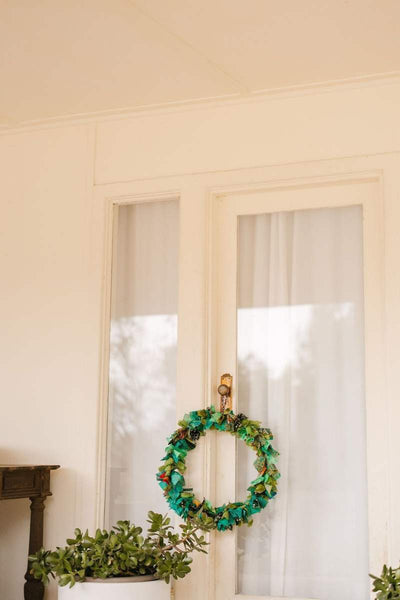 Decorative wreath on a door with a neutral background by Mink and Me