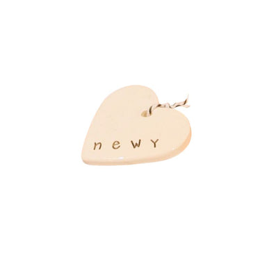 Newy Heart Tag by Caroline C with small ribbon. Made from ceramic with NEWY printed on the edge.