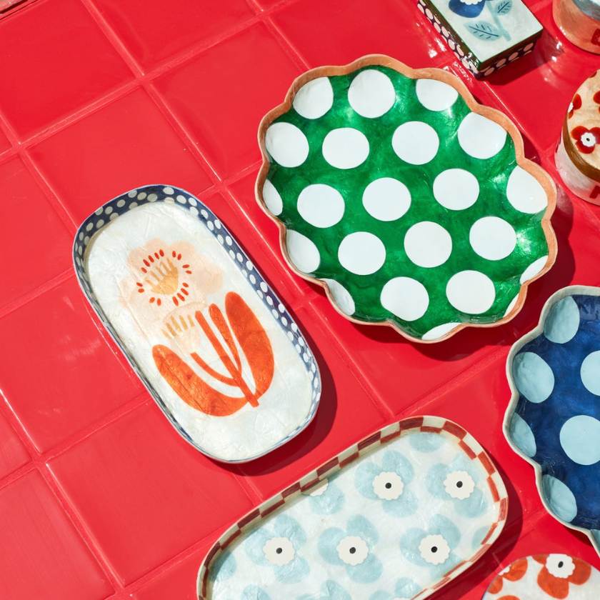 Set of colorful plates with different patterns on a red surface