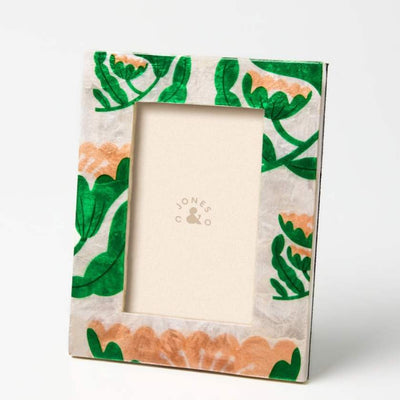 Decorative picture frame with floral design on a white background