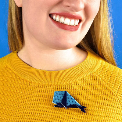 Prince of wales brooch on model's jumper by Erstwilder, from their 2023 Origami collection