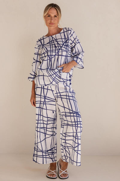 Woman wearing a blue and white patterned outfit on a beige background by See Saw | See Saw Stockist at Zebra Finch marketown in Newcastle, NSW