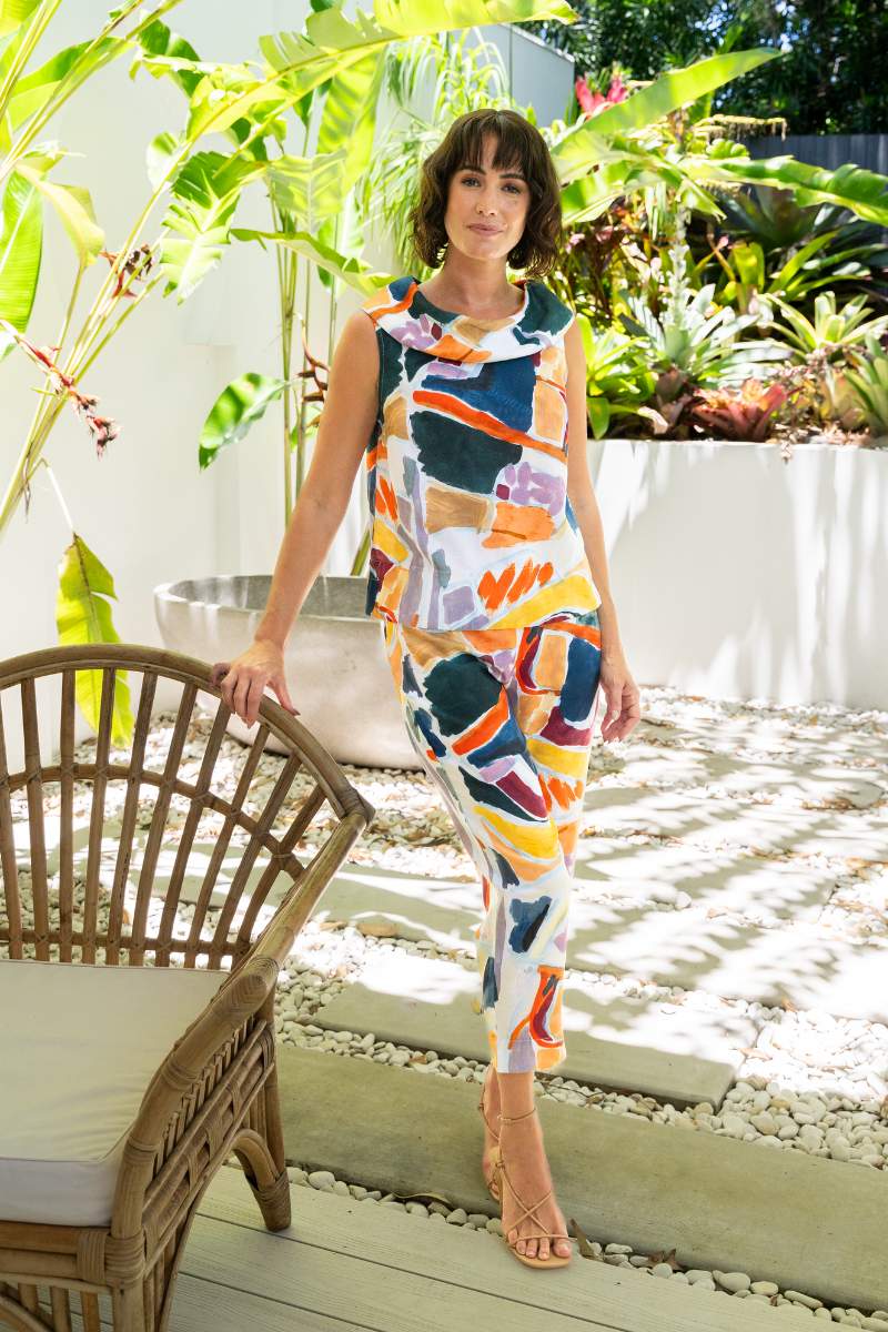 Woman in a colorful outfit standing in a garden setting