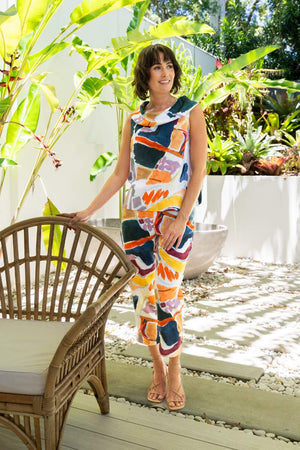 Woman in a colourful outfit standing in a garden setting