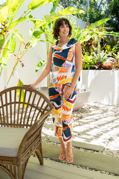 Woman in a colourful outfit standing in a garden setting