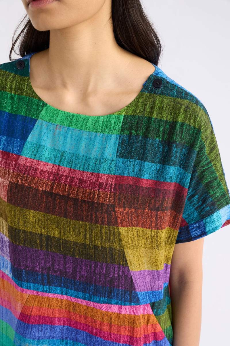 Multicoloured striped shirt worn by a person on a white background