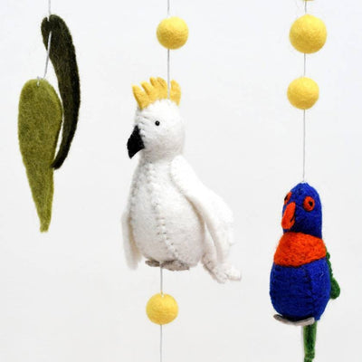 Decorative mobile with white parrot, colorful parakeet, and hanging leaves on a white background
