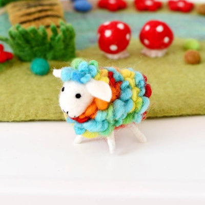 Colorful woolly sheep toy with a garden background