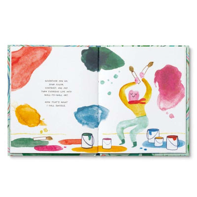 Open book with colorful illustrations of a person painting and abstract shapes on a white background