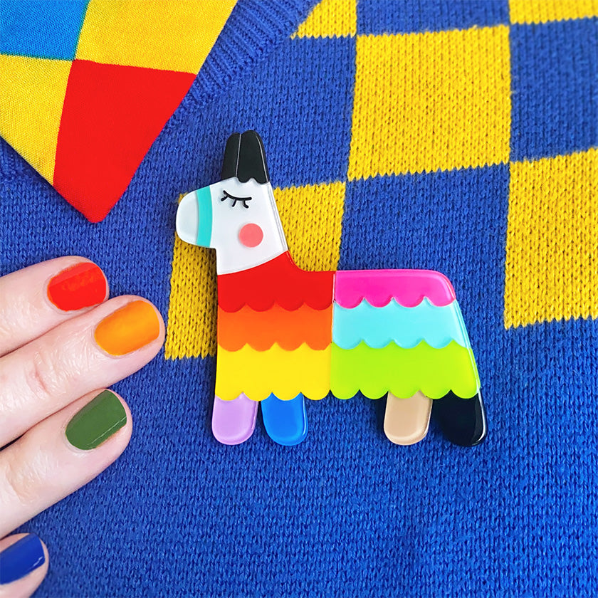 Viva Pride Pinata resin brooch from Erstwilder's 2023 Pride and Joy collection on colourful jumper