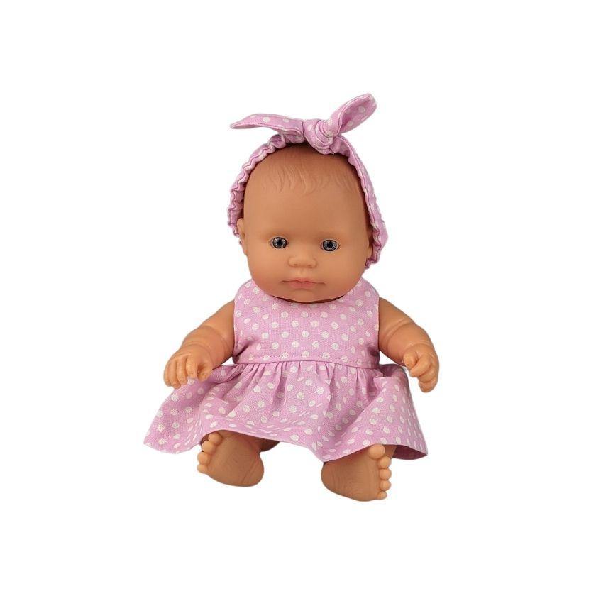 Doll in pink dress with white spots and a pink headband