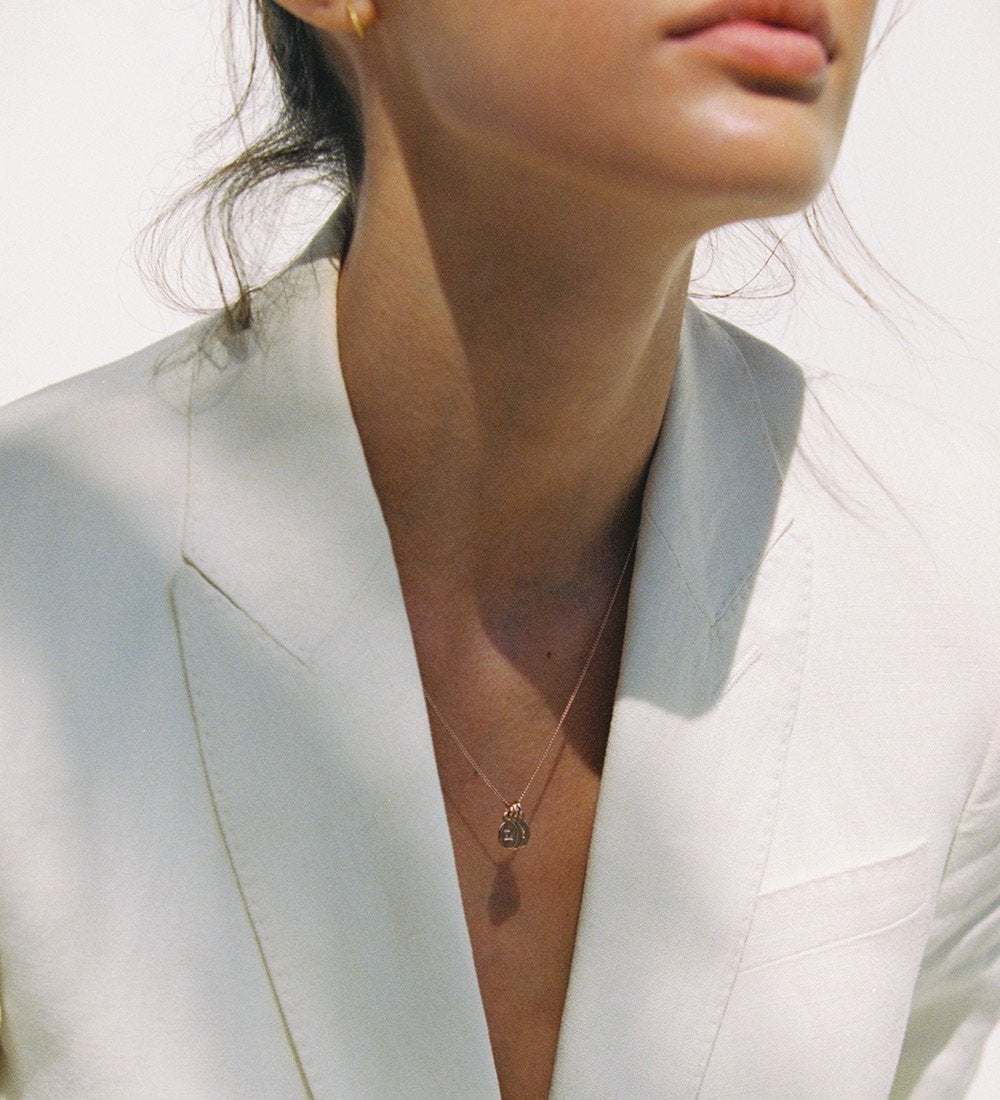 Model wearing Rose gold necklace chain with initial charms