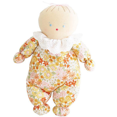 Awake asleep doll with light skin and orange marigold floral design with eyes open