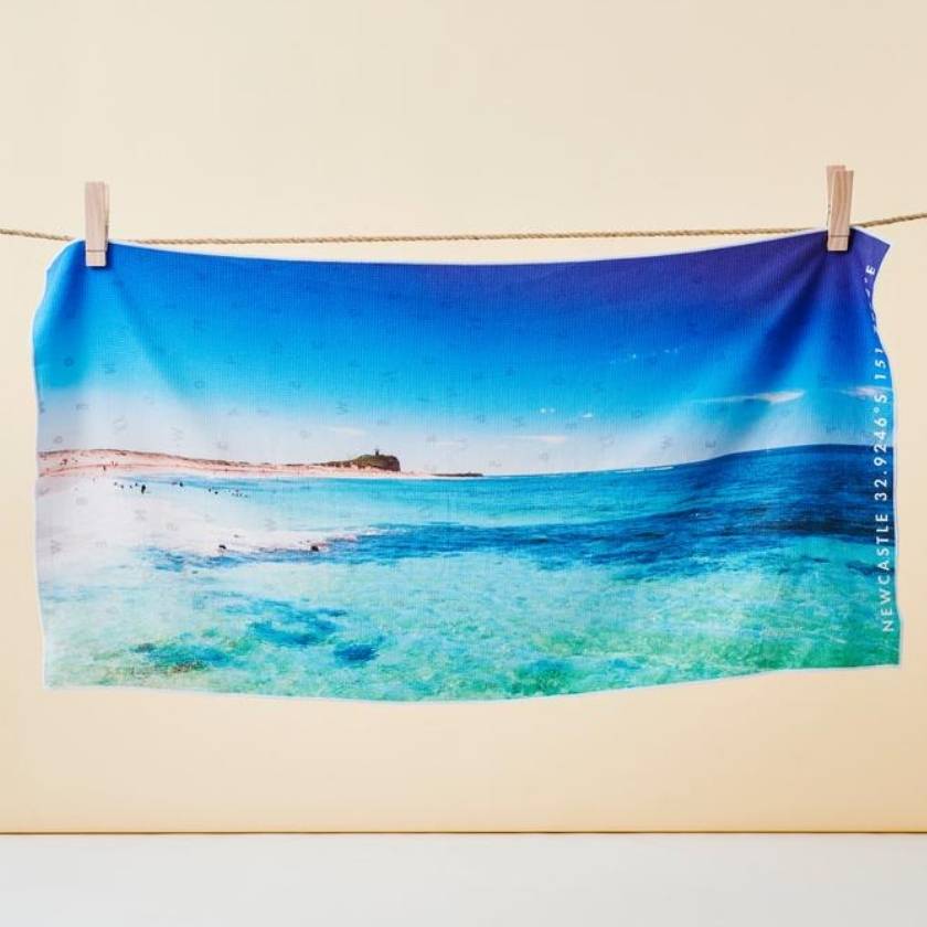 Sand free beach towel with a picture of Newcastle on it