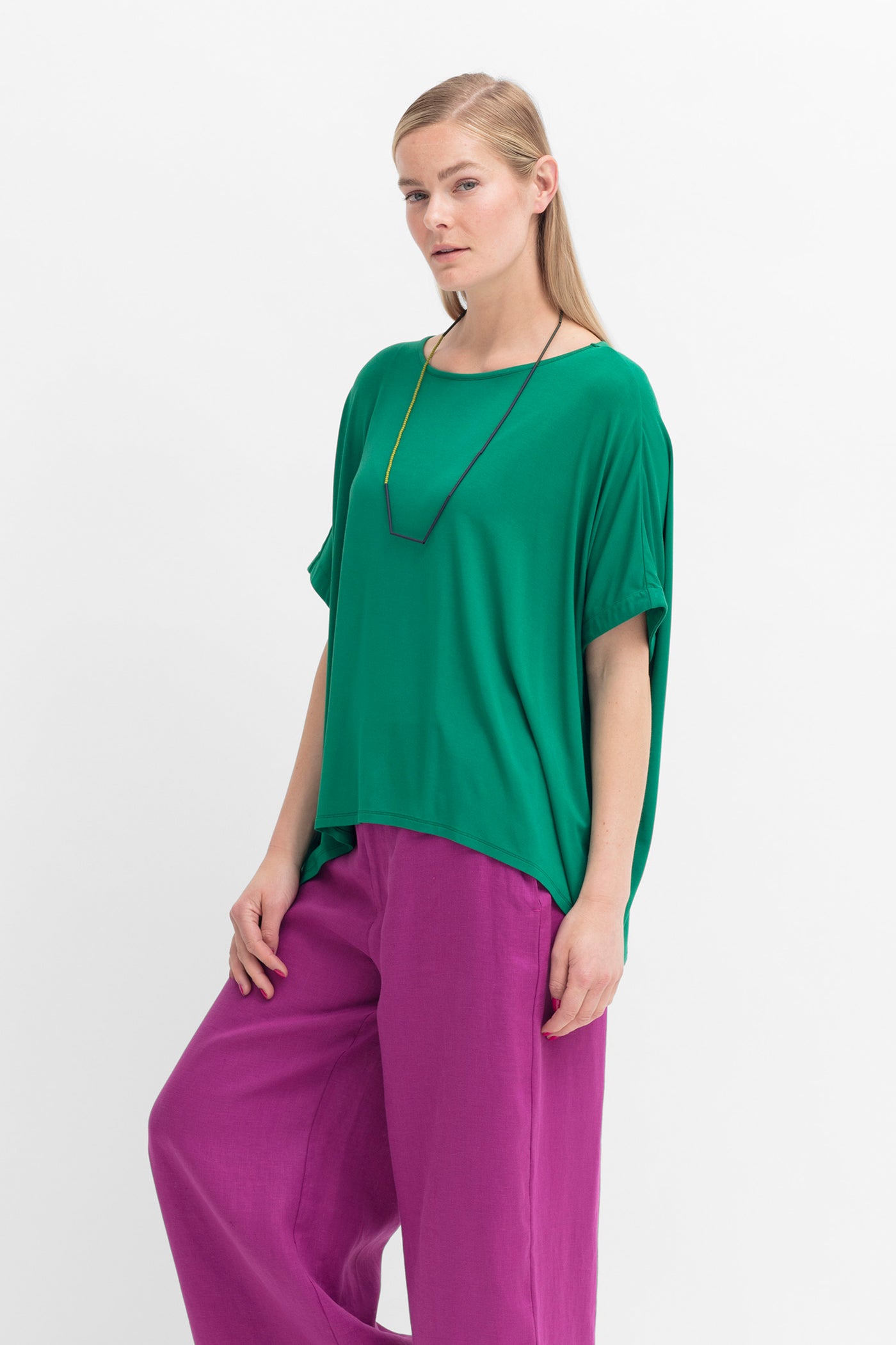 Model wearing Cedar Green Telse T-Shirt by Elk the Label and Wild Berry Anneli Pants
