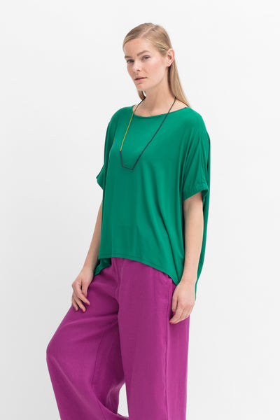 Model wearing Cedar Green Telse T-Shirt by Elk the Label and Wild Berry Anneli Pants