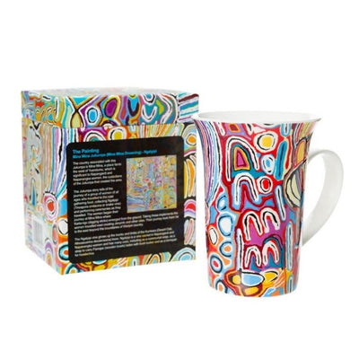 Judy watson bright blue, pink, red and orange artwork on ceramic coffee mug next to gift box