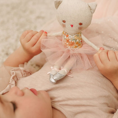 Child playing with floral sweet marigold odette ballerina kitty doll